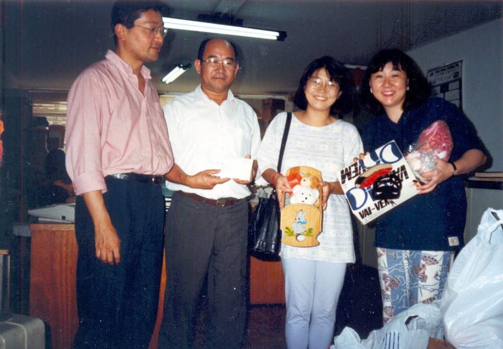 Noriyuki, diretor da Associação Kodomo-no-Sono, que atende crianças e adultos com deficiência mental, profa. Mayumi Ito e Cristiane Sato, entregando a importância arrecada e alguns brinquedos doados pelos associados. Foto de 28/2/2007